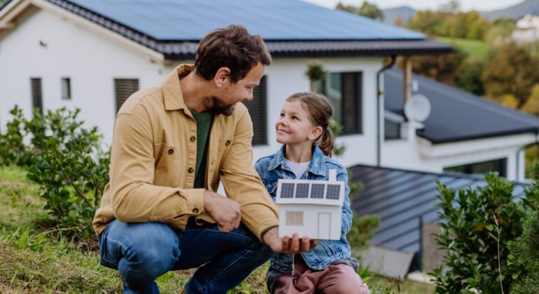 Little,Girl,With,Her,Dad,Holding,Paper,Model,Of,House